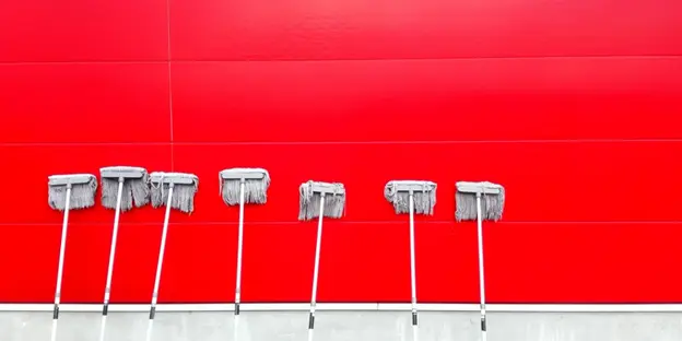 seven mops against red wall