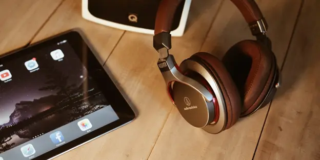 headphones and other tech devices on top of table