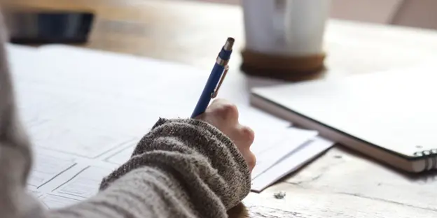 woman sketching on paper