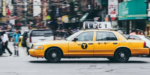 yellow cab driving in city