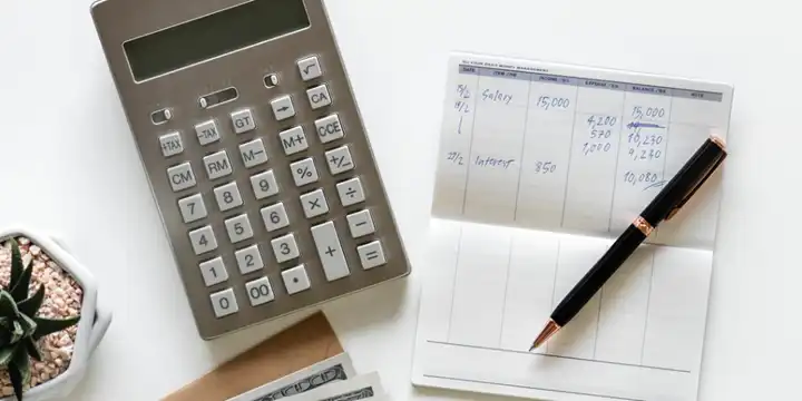 checkbook and calculator on table