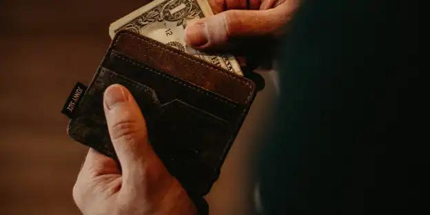 man looking through wallet