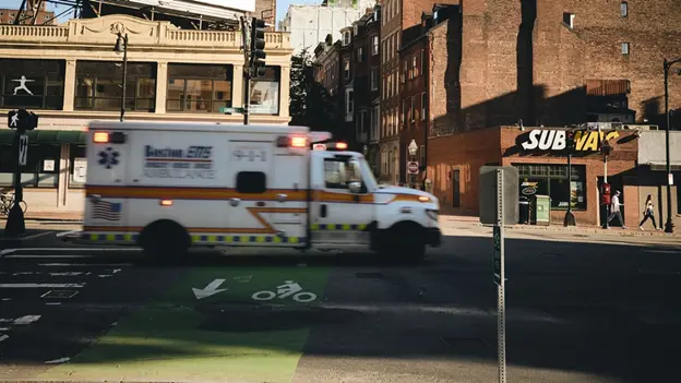 ambulance rushing by with lights and sirens on