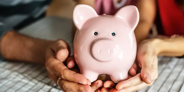 woman and child holding piggy bank