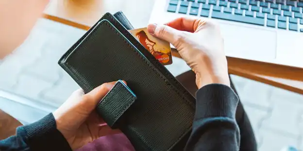 woman pulling card out of wallet