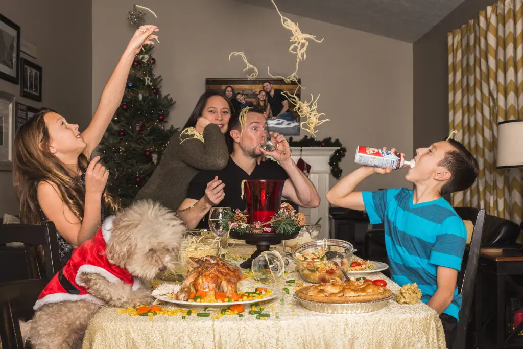 Chaotic Thanksgiving dinner with food flying in the air