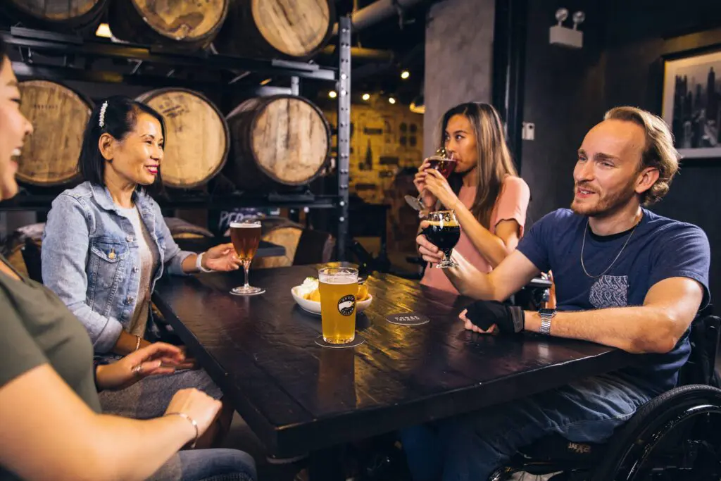 people gathered around table having drinks