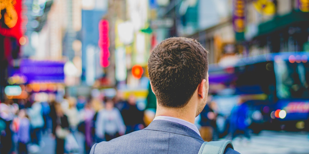man in suit looking at the streets of New York