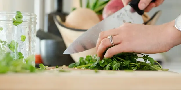 woman chopping cilantro