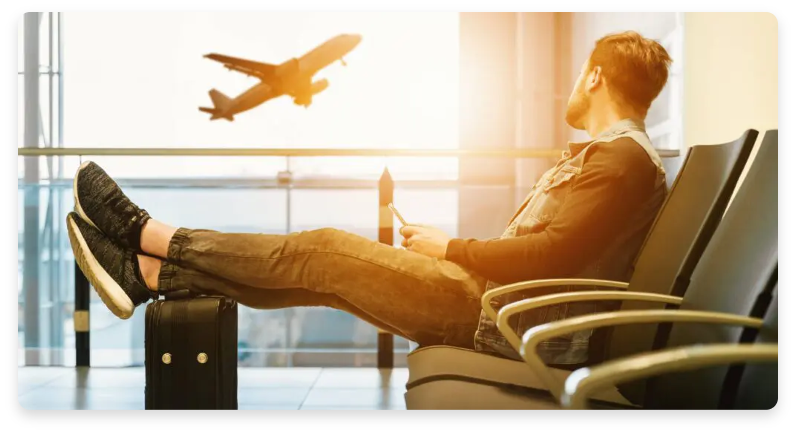 Guy laying in chair in the airport