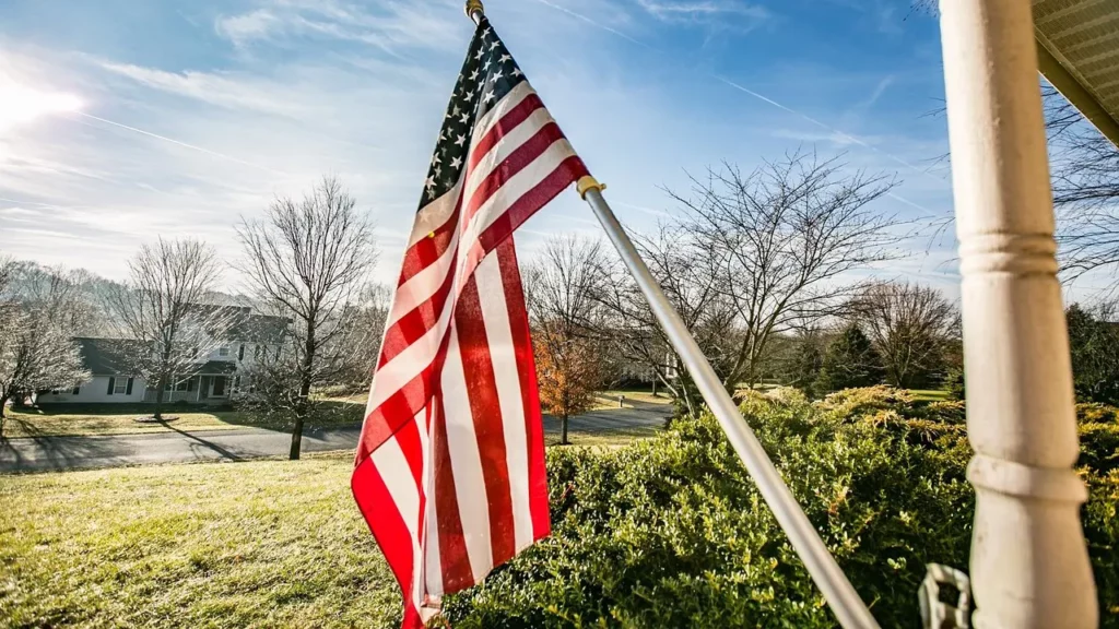 An American flag set up on a porch.