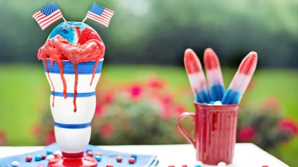 Ice-cream and popsicles in red, white, and blue hues. Two miniature American flags are added on the top of the ice cream.