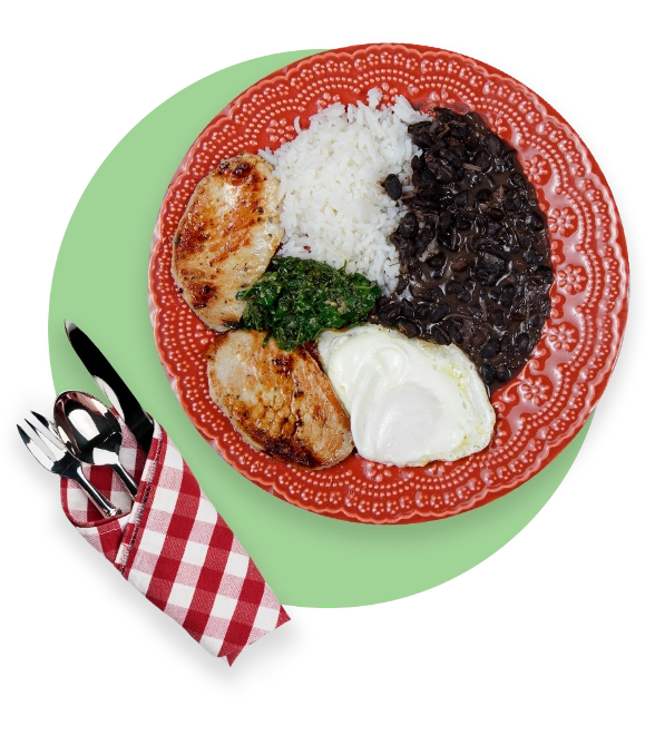 Plate with rice, chicken, beans, spinach, and mashed potatoes with cutlery in a napkin next to plate